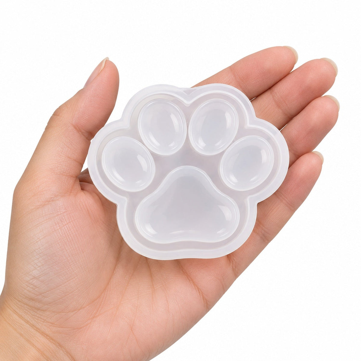 Hand holding one of the kit's silicone molds to show its size