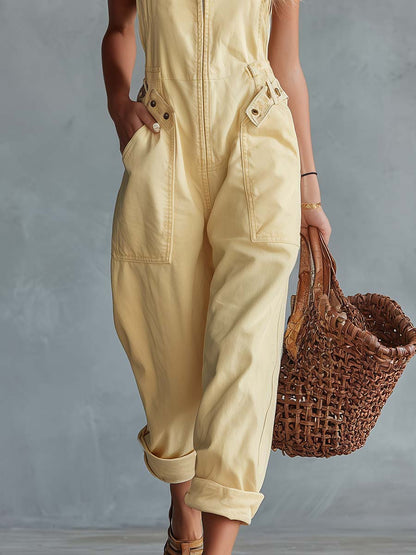 Light yellow denim jumpsuit for women with square neckline and zip-front, by Christine Brewer, featuring stylish pant silhouette.