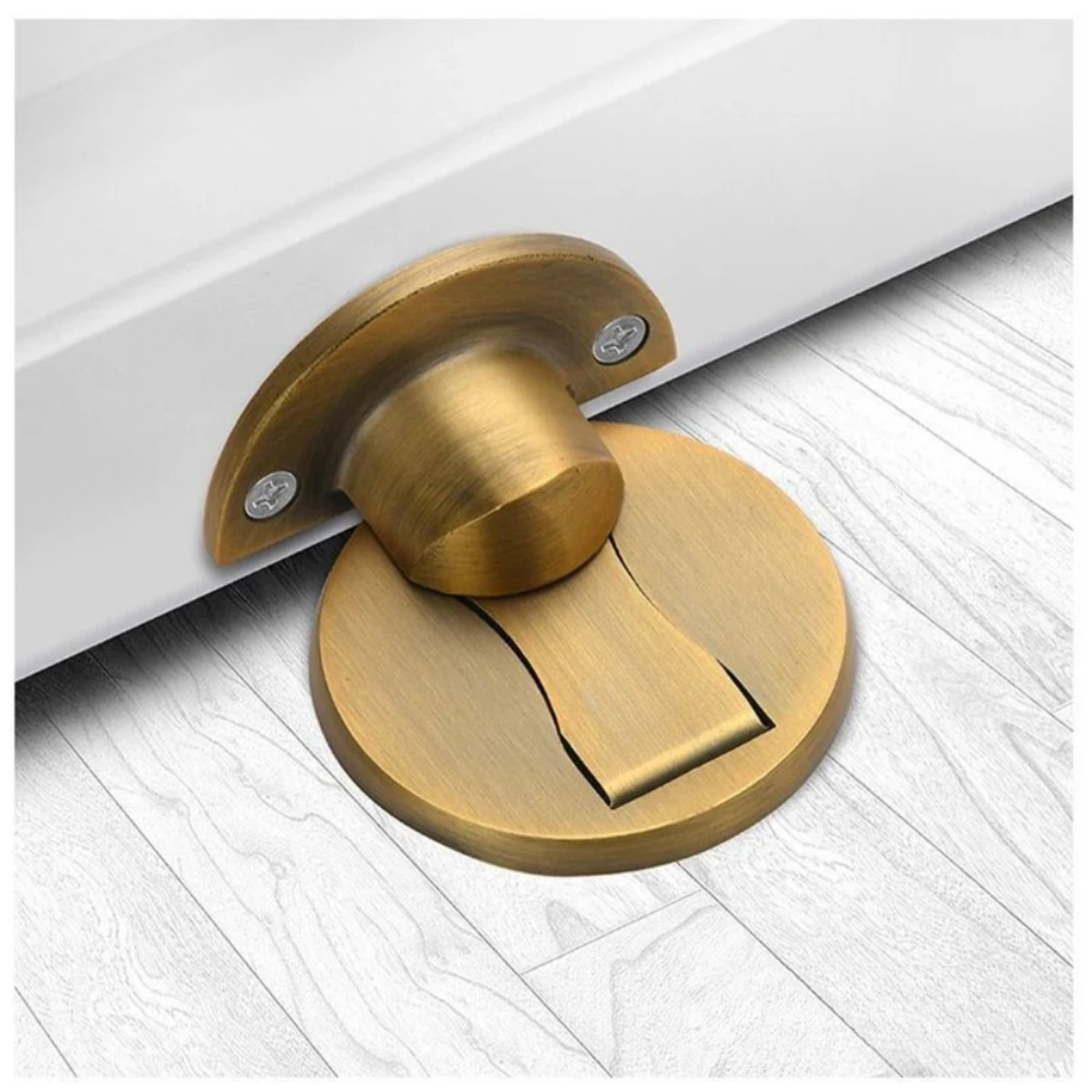 Gold door stopper on a white wooden floor