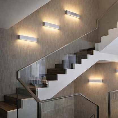Wall Light six aluminium LED wall lights with up and down lighting mounted along a staircase in a modern hallway