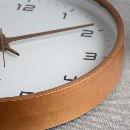 Close-up of a clock with a brown frame on a textured surface