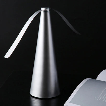 Modern silver table lamp with a black background