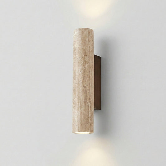 Cylindrical wall light fixture on a plain wall