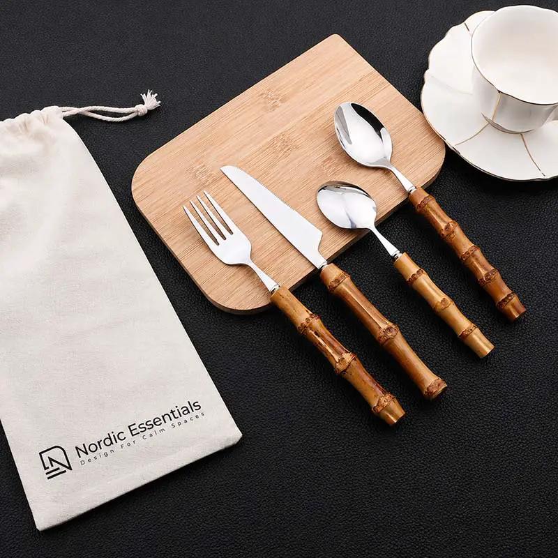 24-Piece Bamboo Handle Cutlery Set in Stainless Steel: bamboo-handled utensils on board with Nordic Essentials pouch