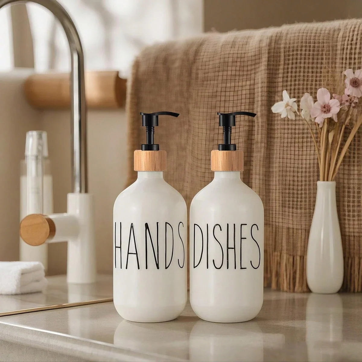 Two white soap dispensers labeled 'HANDS' and 'DISHES' on a bathroom counter.