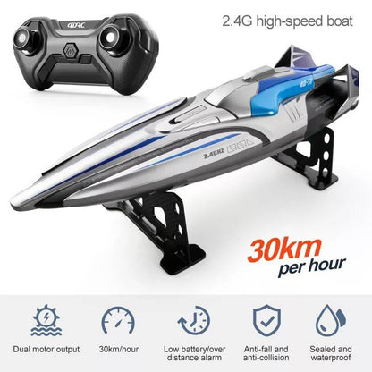 Silver RC racing boat with 2.4GHz remote control, studio shot