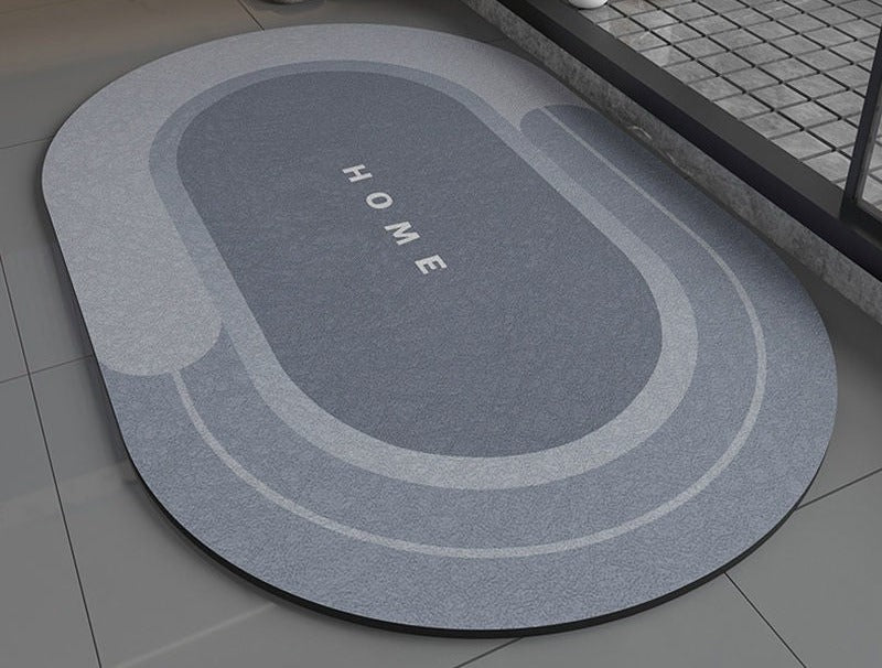 Green oval bathroom non slip rug with 'HOME' text on a bathroom floor