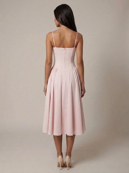 Back view of blush corset midi dress showing zip closure