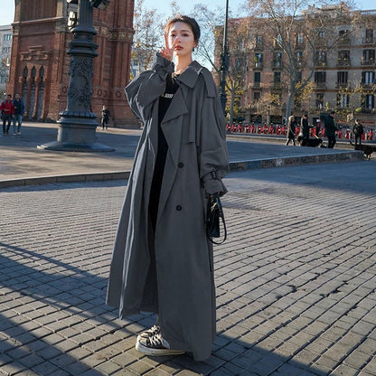 Emily women's oversized double-breasted longline trench coat by Christine Brewer, shown in a stylish, beige fabric with wide lapels.
