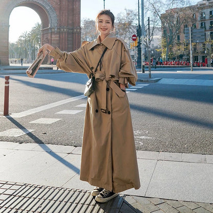 Emily women's oversized double-breasted longline trench coat by Christine Brewer, shown in a neutral color with wide lapels and belt.